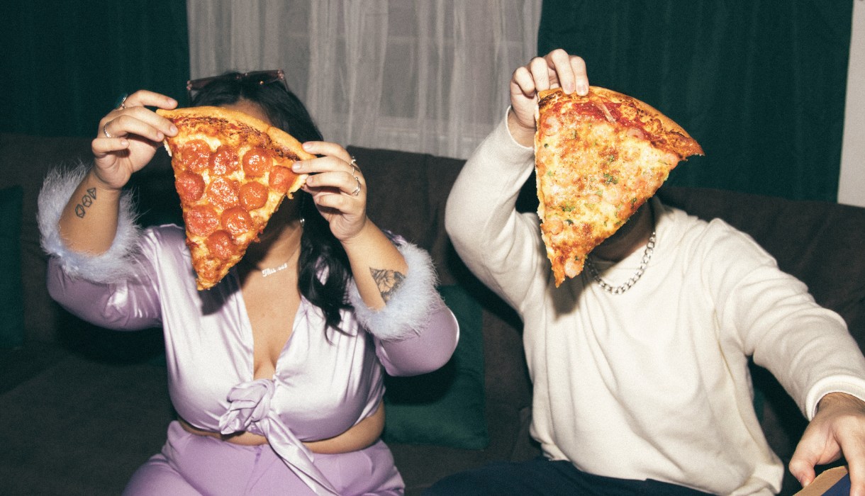 People Holding Up Pizza Slices at one of the pizza places in salt lake city ut Image by Kitkat Pajaro from capturenow