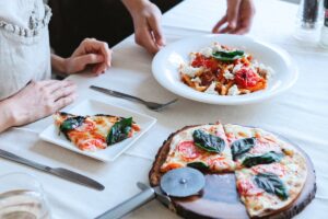 Woman at one of the Italian Restaurants Photo by Antonius Ferret from Pexels